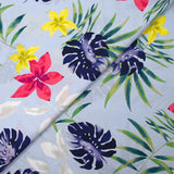 Popeline de coton imprimée fleurs tropicales fond bleu ciel
