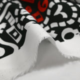 Satin de coton léger imprimé graffitis blanc et rouge fond noir