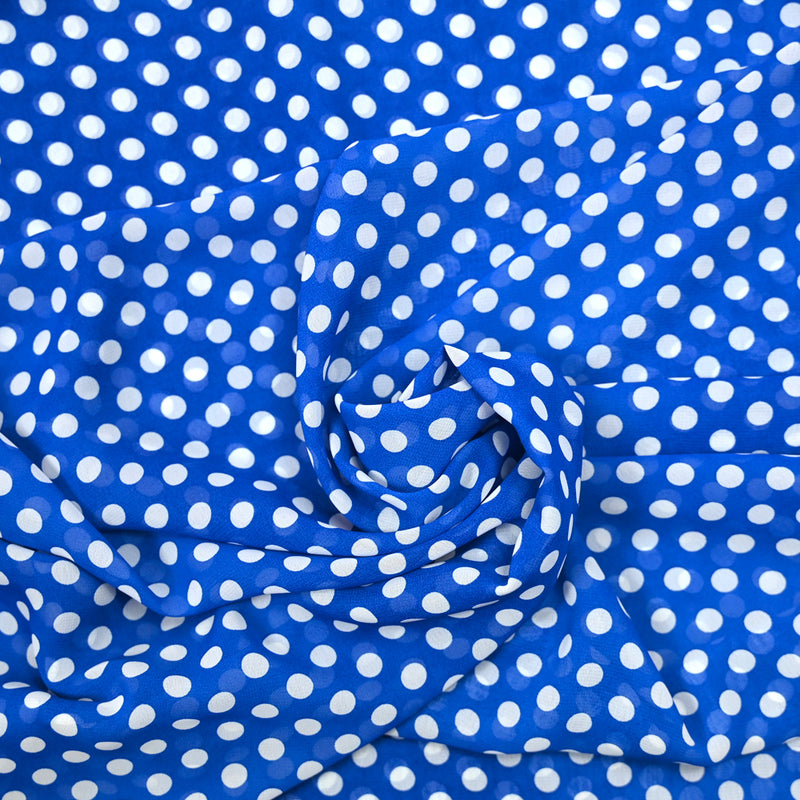 Mousseline de polyester imprimée pois blanc fond bleu