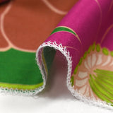 Twill de viscose imprimé en fleurs anis et fuchsia fond vert prairie