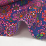 Velours de coton côtelé imprimé fleurs psychédéliques fond indigo