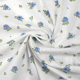 Coton imprimé les fleurs de Lou bleu fond blanc