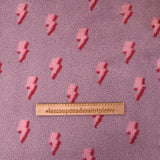 Fausse fourrure sherpa éclairs fond lilas