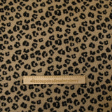 Fausse fourrure sherpa léopard noir fond marron