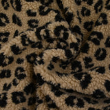 Fausse fourrure sherpa léopard noir fond marron