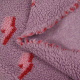 Fausse fourrure sherpa éclairs fond lilas