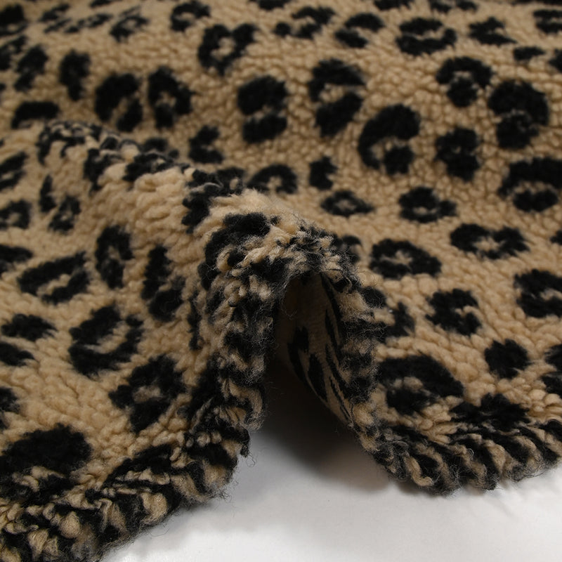 Fausse fourrure sherpa léopard noir fond marron