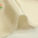 Polyester satin embroidered peach flowers ivory background