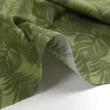 Coton imprimé envolée de feuilles fond vert