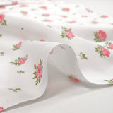 Coton imprimé les fleurs de Lou rose fond blanc
