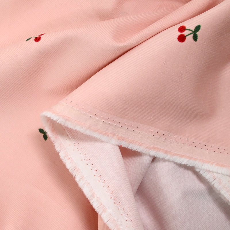 Velours de coton côtelé imprimé cerise fond rose