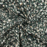 Punto de algodón arrugado con estampado de terrazo, fondo verde oscuro