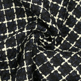 Wool blend tweed with ecru checks on navy and black background