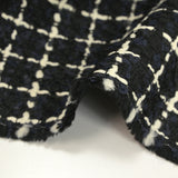 Wool blend tweed with ecru checks on navy and black background