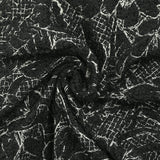Lainage bouclette brodé esquisse florale fond noir
