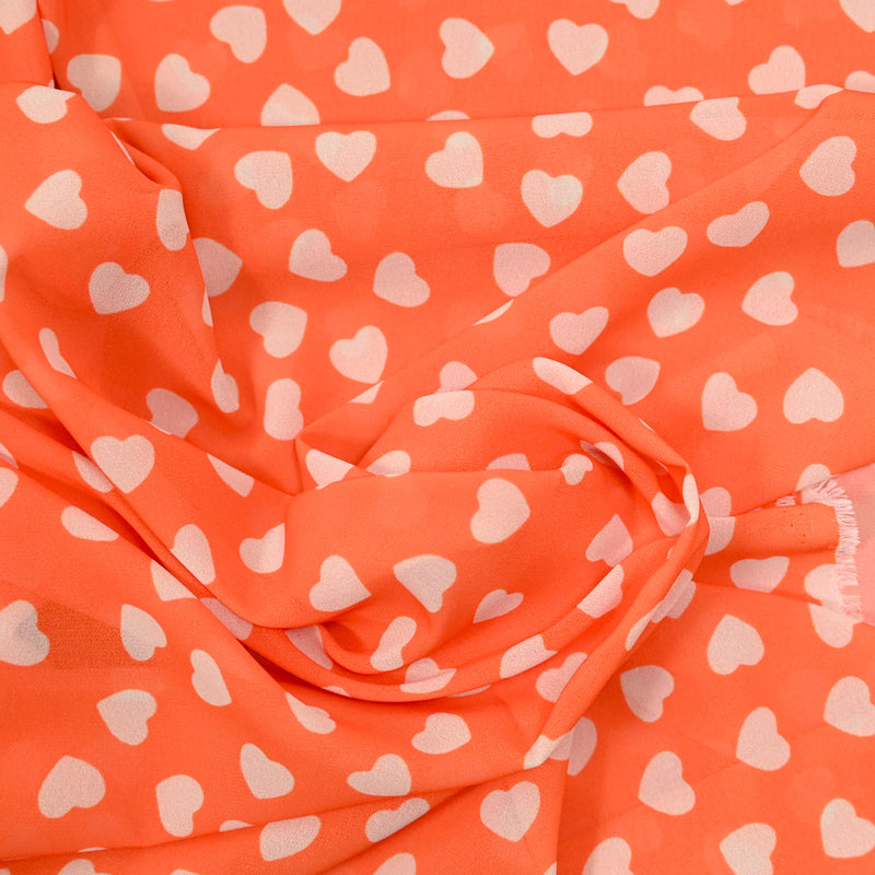 Mousseline de polyester imprimée coeur fond orange