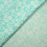 Jacquard de polycoton liaison de fleurs fond turquoise