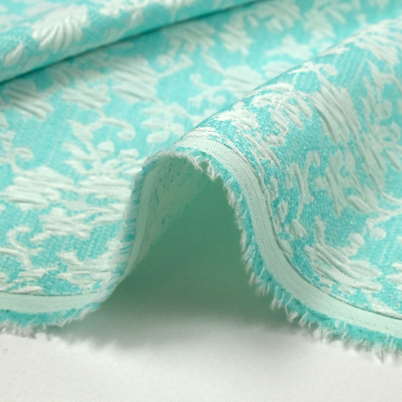 Jacquard de polycoton liaison de fleurs fond turquoise