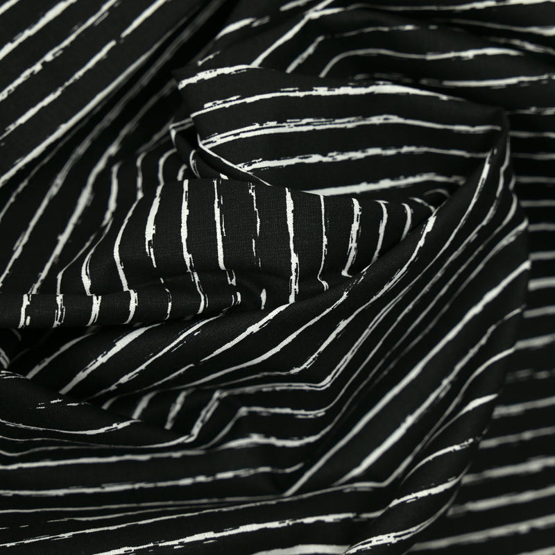 Fondo negro con rayas estampadas con estampado de algodón
