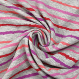 Red, pink and purple striped cuddly sweatshirt with heather gray background