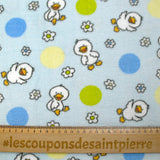 Fleet comforter printed with flowers and ducklings on a sky blue background