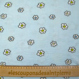 Fleet comforter printed with flowers and ducklings on a sky blue background