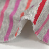 Red, pink and purple striped cuddly sweatshirt with heather gray background