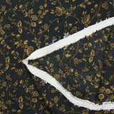 Voile de viscose imprimé branches de fleurs ocre fond noir