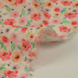Viscose imprimée spirale de fleurs roses et orange fond écru