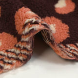Salmon and ecru leopard faux sherpa fur, dark plum background