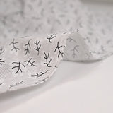 Popeline polycoton imprimée rayée et branche fond gris