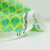 Popeline enduite imprimée végétal turquoise fond citron