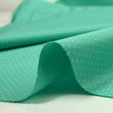Coton imprimé mini pois fond turquoise