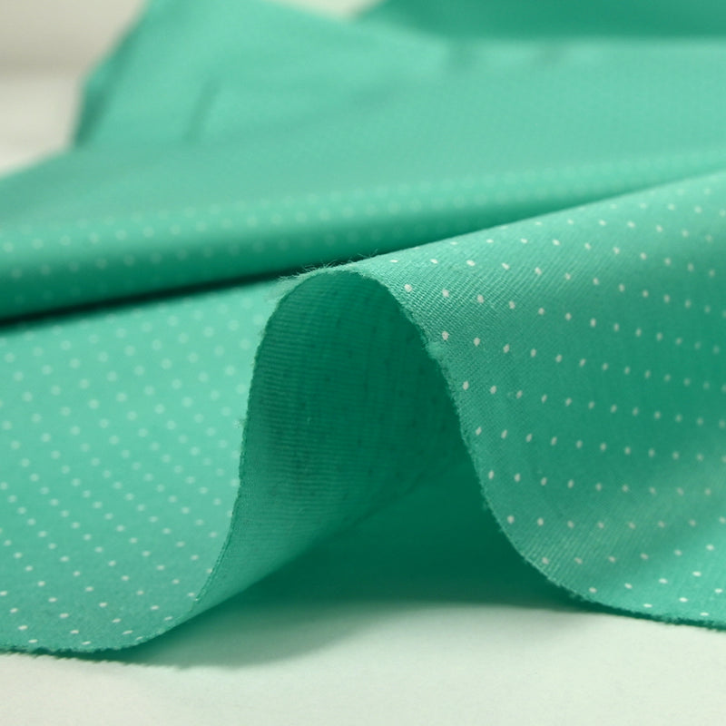 Coton imprimé mini pois fond turquoise