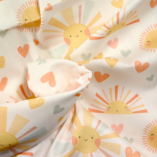 Coton imprimé soleil fond blanc cassé