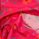 Coton imprimé fleurs fond magenta