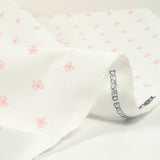 Coton imprimé noeud rose fond blanc