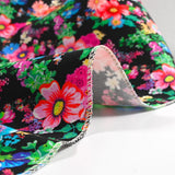 Sergé de coton et viscose champs de fleurs fond noir