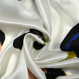 Silk satin printed with stylized flowers off-white background
