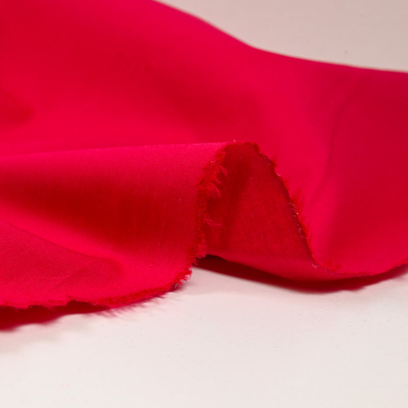 Popeline de coton et élasthanne framboise