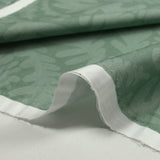 Printed cotton poplin The leaves steal green background water