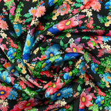 Satin polyester imprimé champs de fleurs fond noir