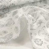 Piqué de coton imprimé papillons et fleurs fond blanc