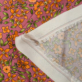 Crêpe viscose imprimé fleurs orange fond cassis glacé