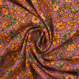 Crêpe viscose imprimé fleurs orange fond cassis glacé