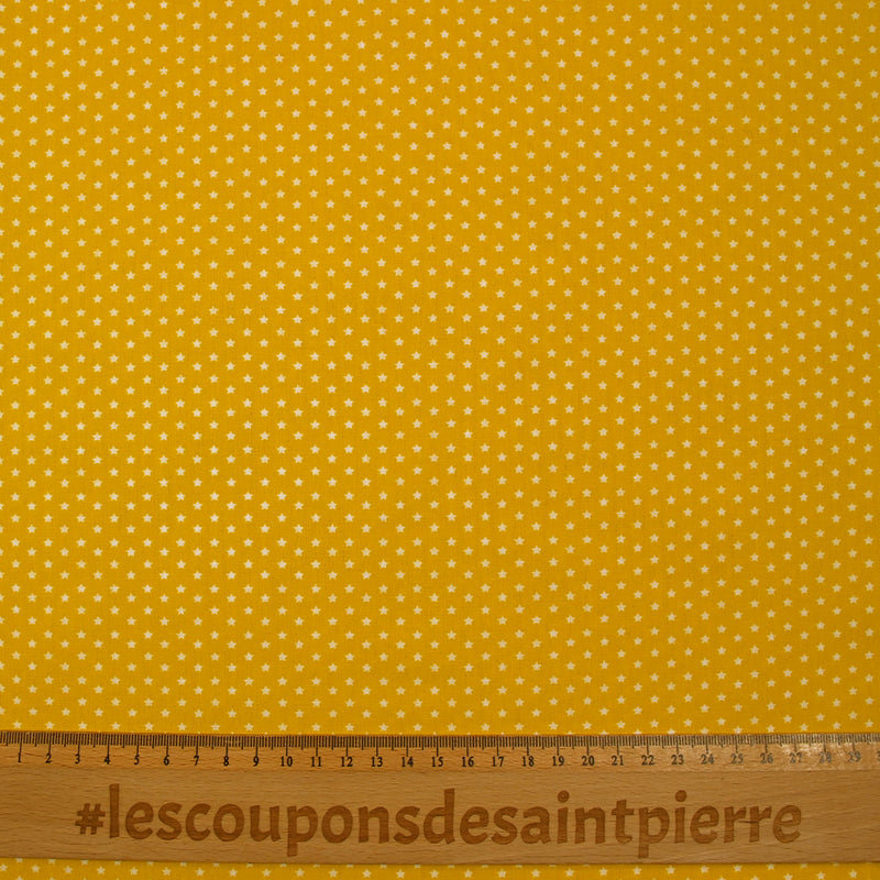 Popeline de coton imprimée mini étoiles fond jaune