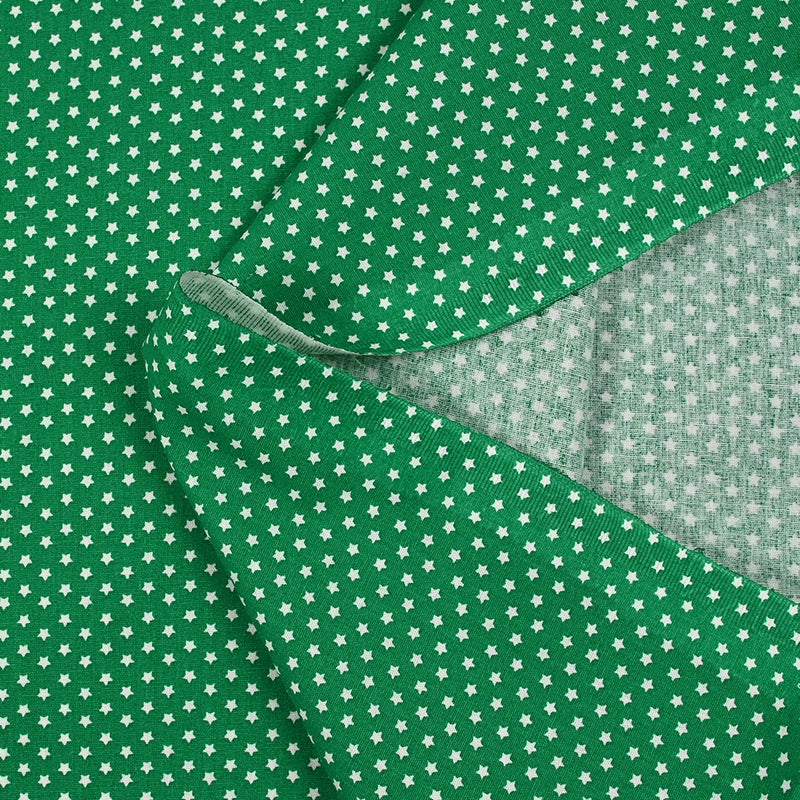 Popeline de coton imprimée mini étoiles fond vert