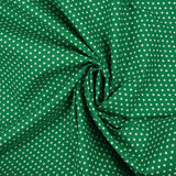 Popeline de coton imprimée mini étoiles fond vert