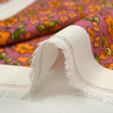 Crêpe viscose imprimé fleurs orange fond cassis glacé