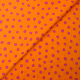 Crêpe satin de polyester imprimé à pois roses fond orange